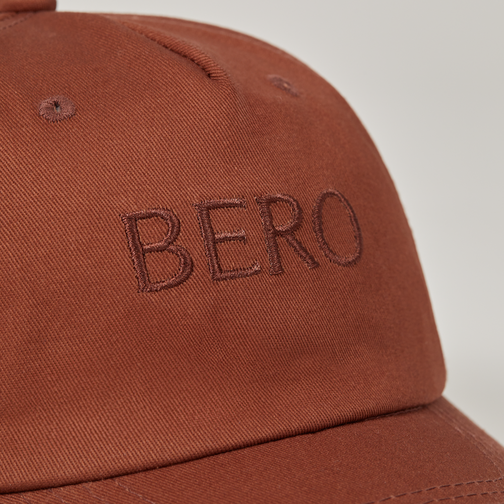 Brown dad cap logo closeup