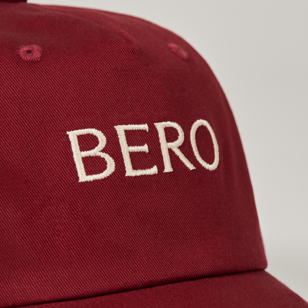 Maroon baseball cap logo closeup