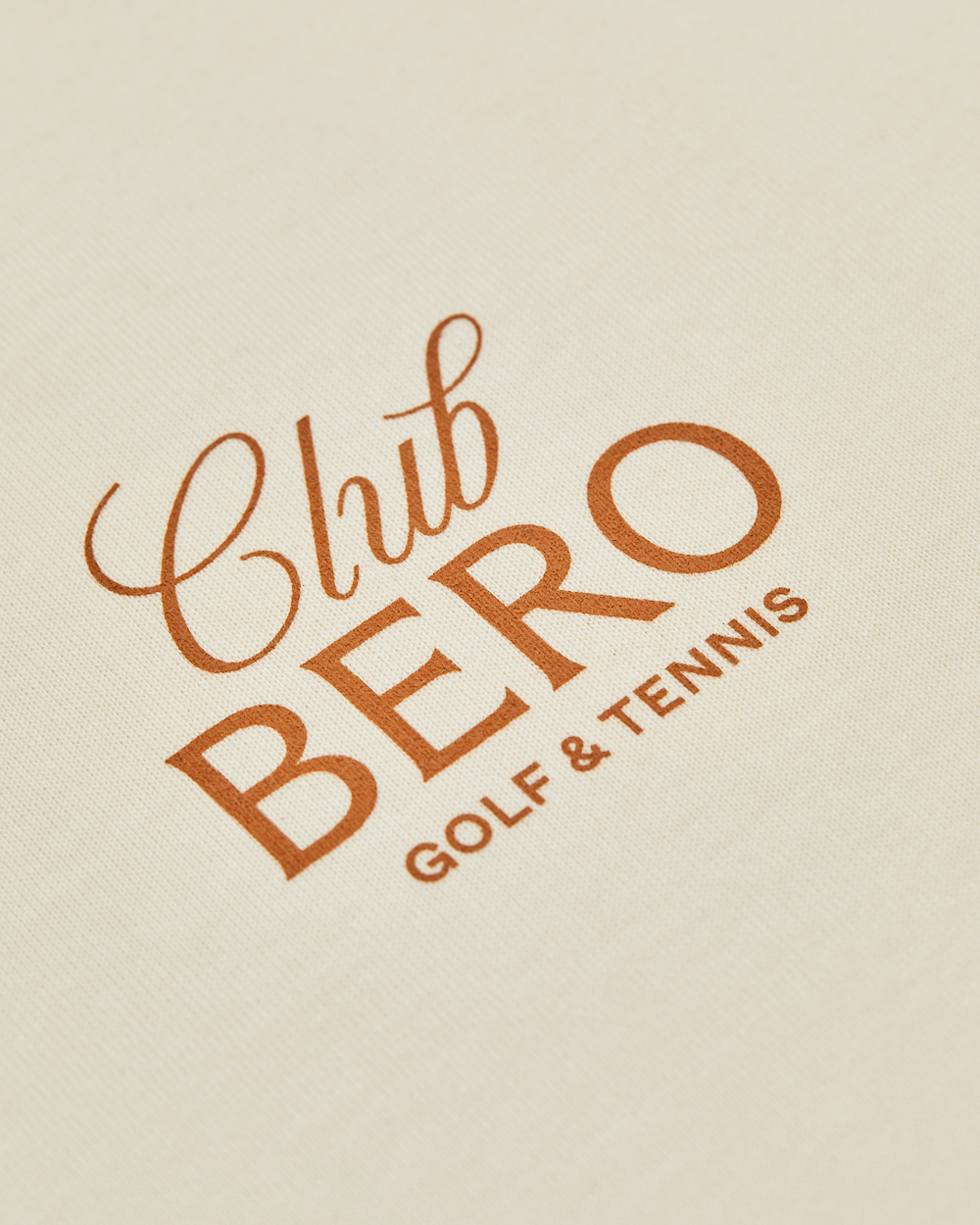 Closeup of Club BERO GOLF & TENNIS logo on tee