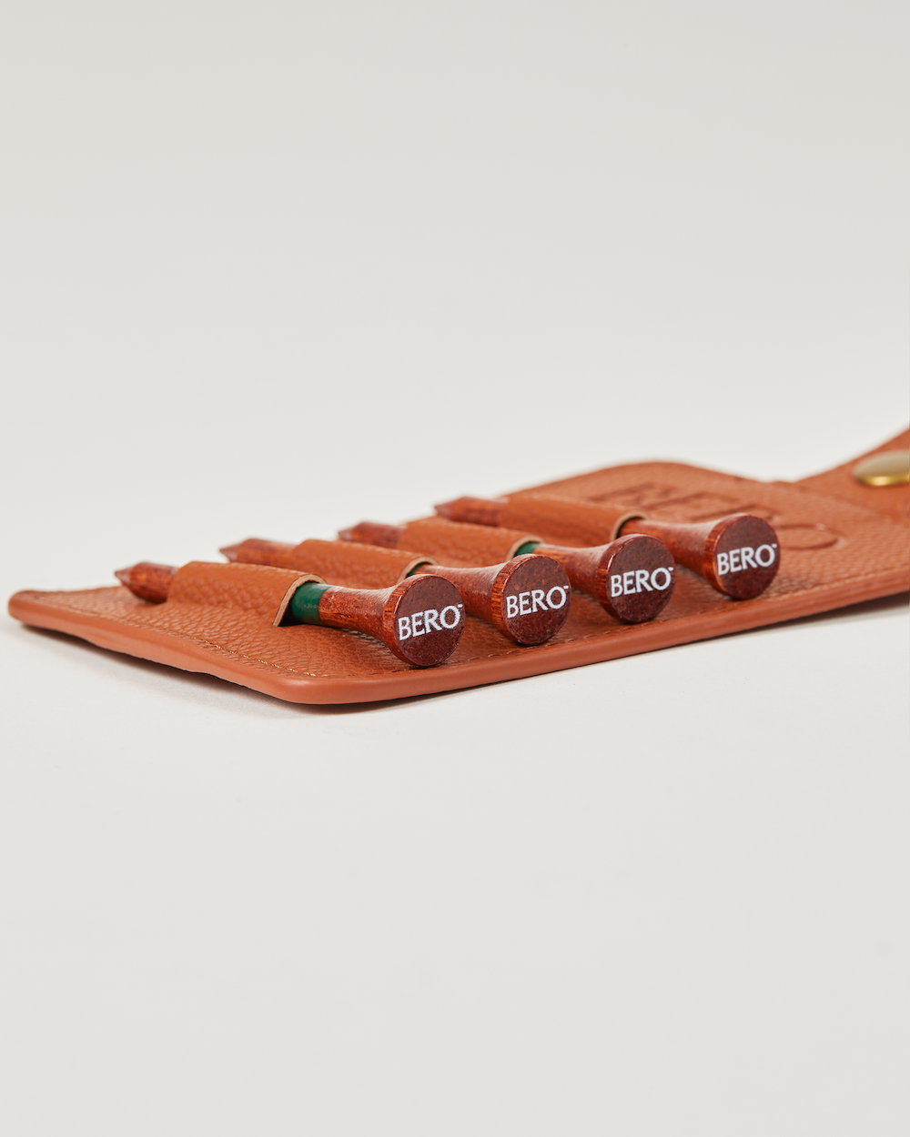 Side view of golf tee holder with four tees