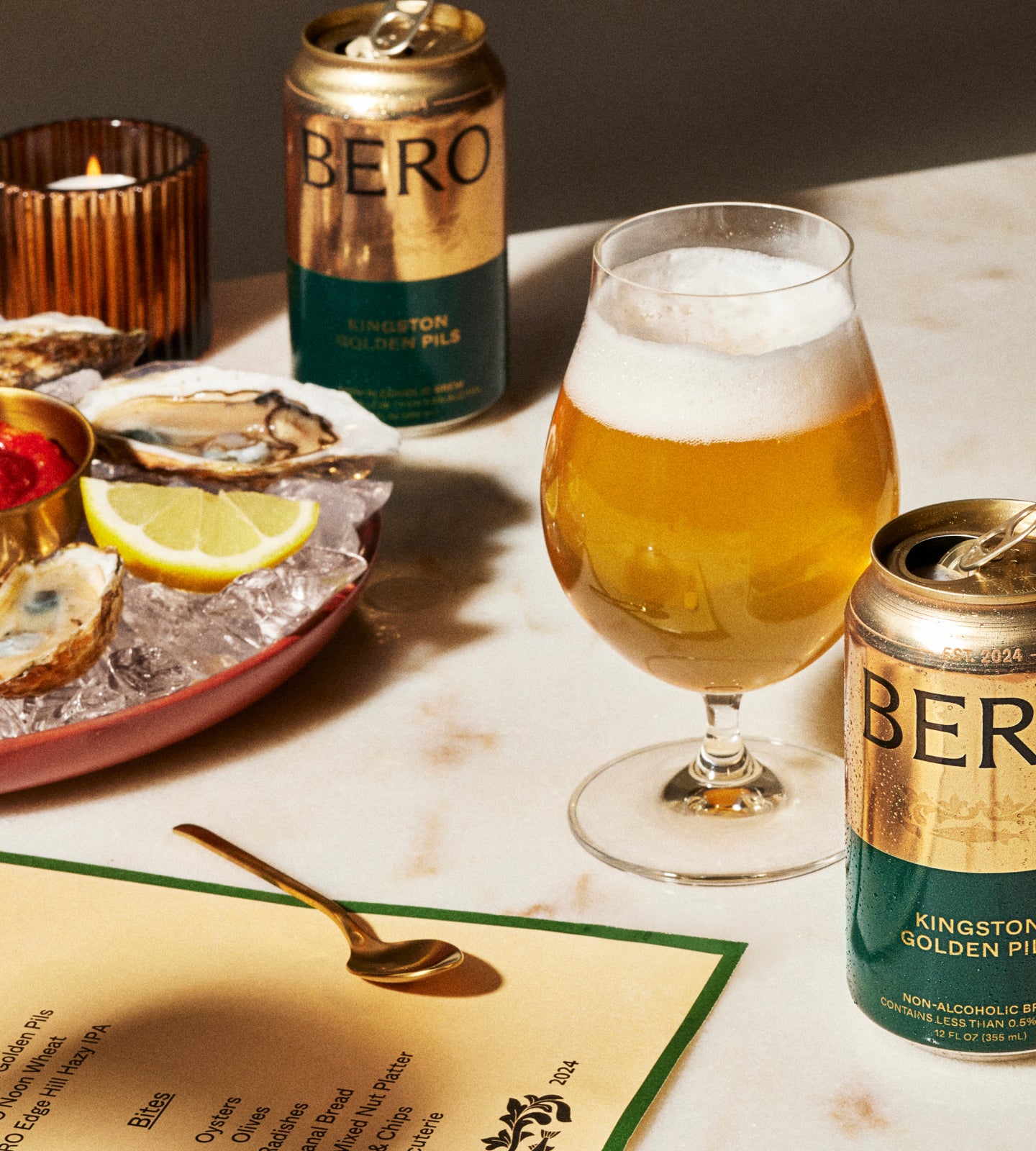 Pils in a glass on a table with oysters