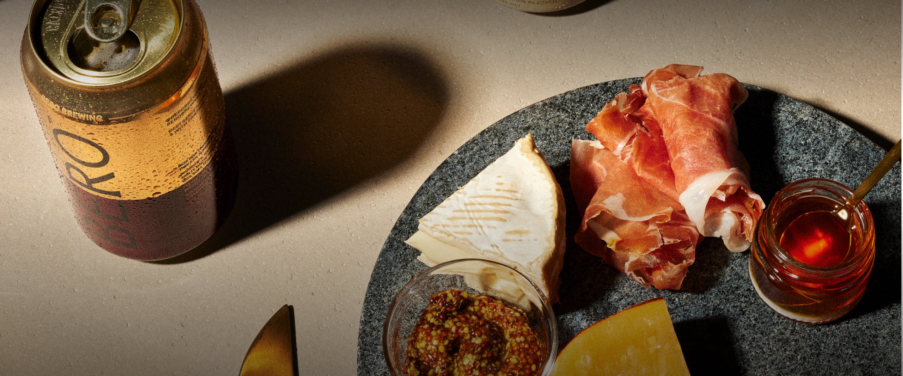 Edge Hill Hazy IPA on a table with charcuterie