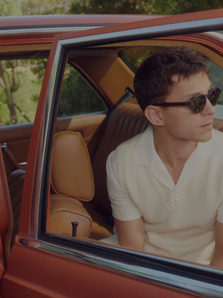 Tom sitting inside a vintage car