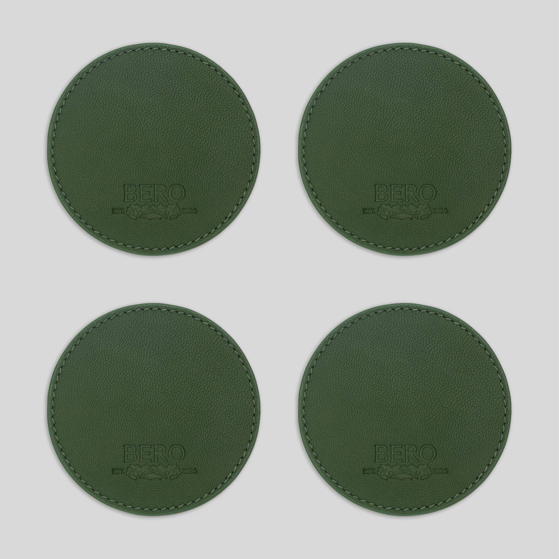 Four green coasters with BERO embroidery
