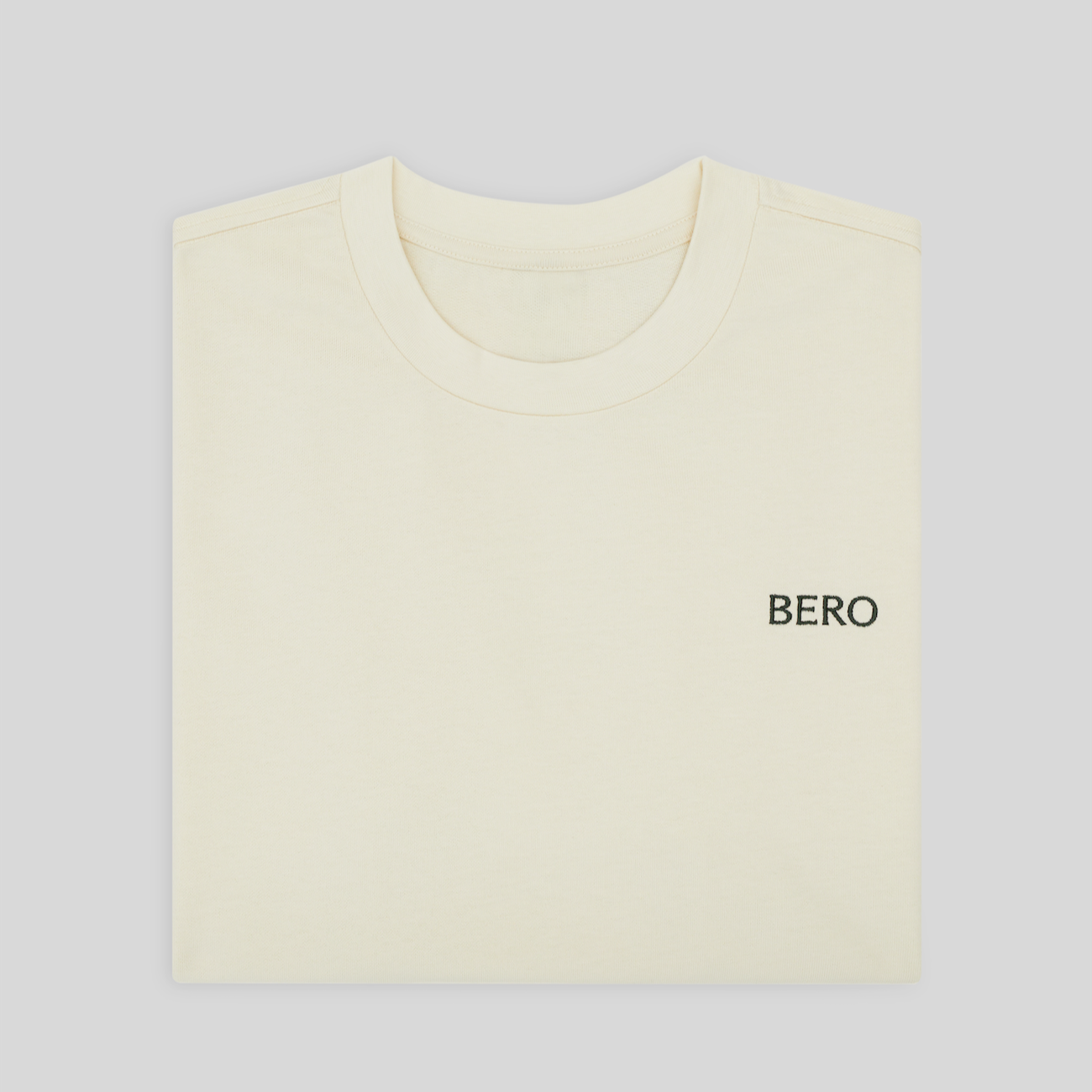 Folded cream t-shirt with 'BERO' logo on left chest