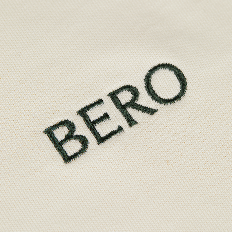 Closeup of BERO embroidery on cream t-shirt