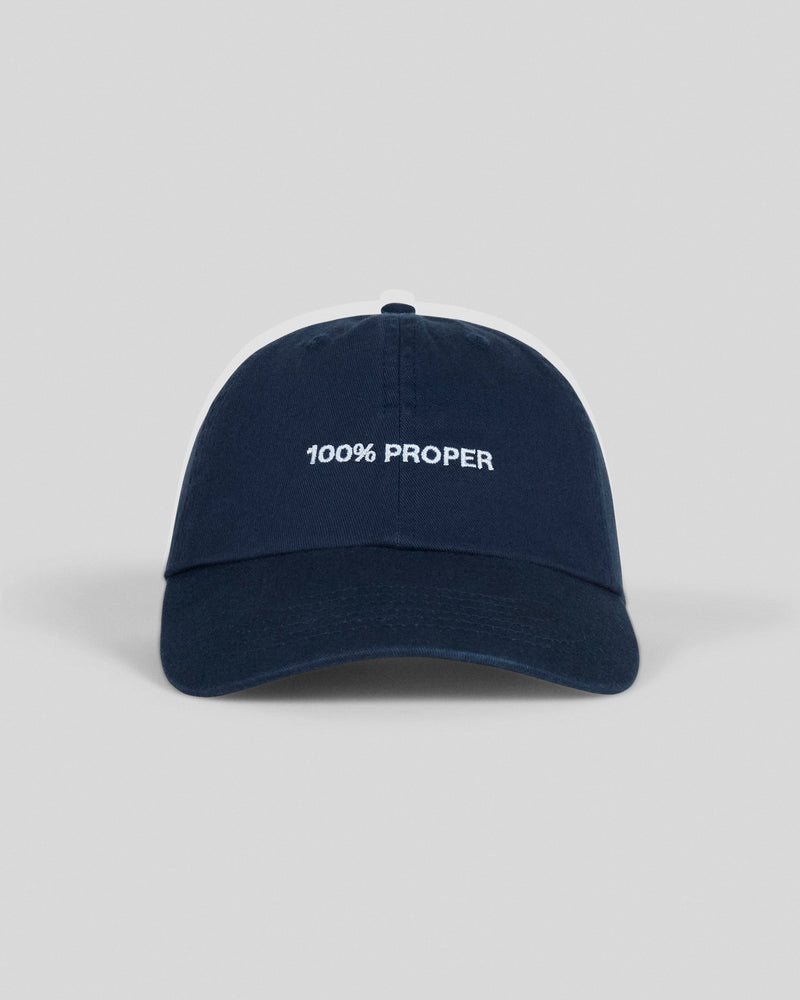Navy blue baseball cap with white embroidered text reading "100% PROPER" on front panel
