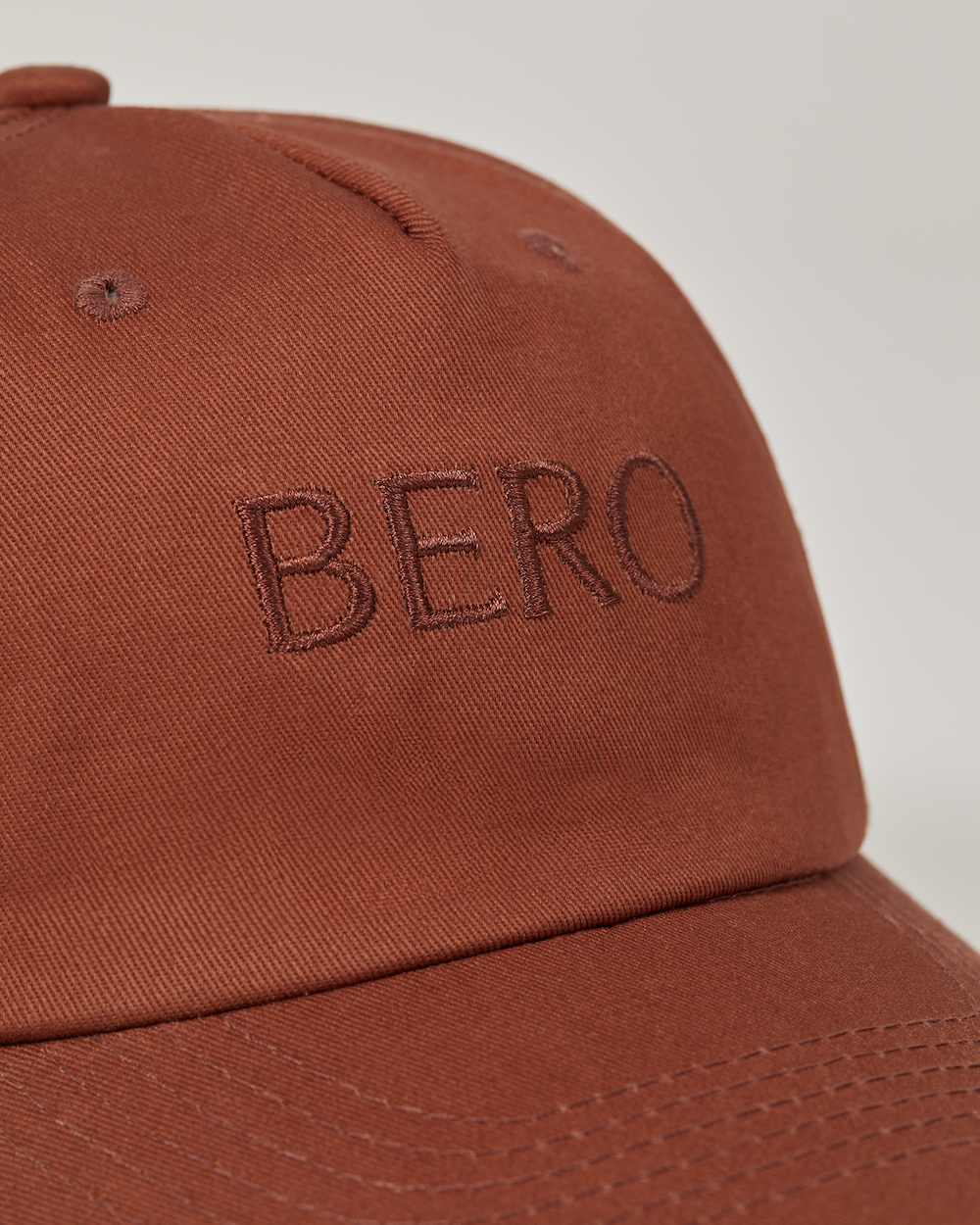 Brown dad cap logo closeup