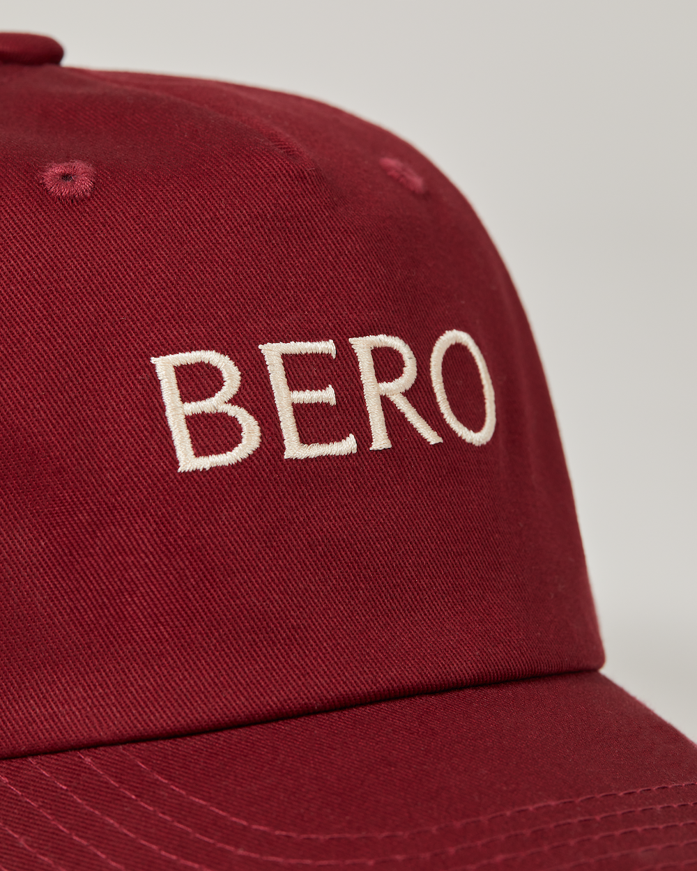 Maroon baseball cap logo closeup