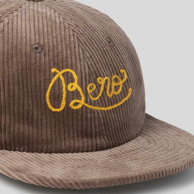Brown corduroy baseball cap with "BERO" embroidered in yellow cursive lettering on the front panel