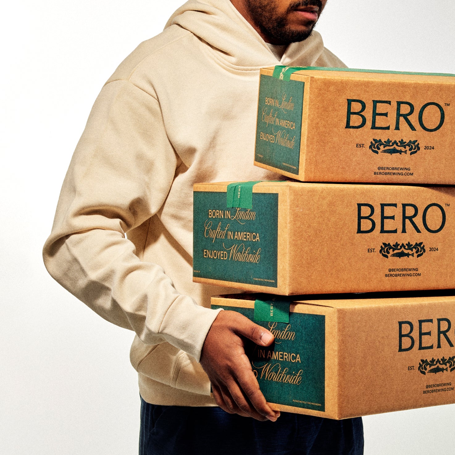 Model with Club BERO hoodie holding BERO boxes
