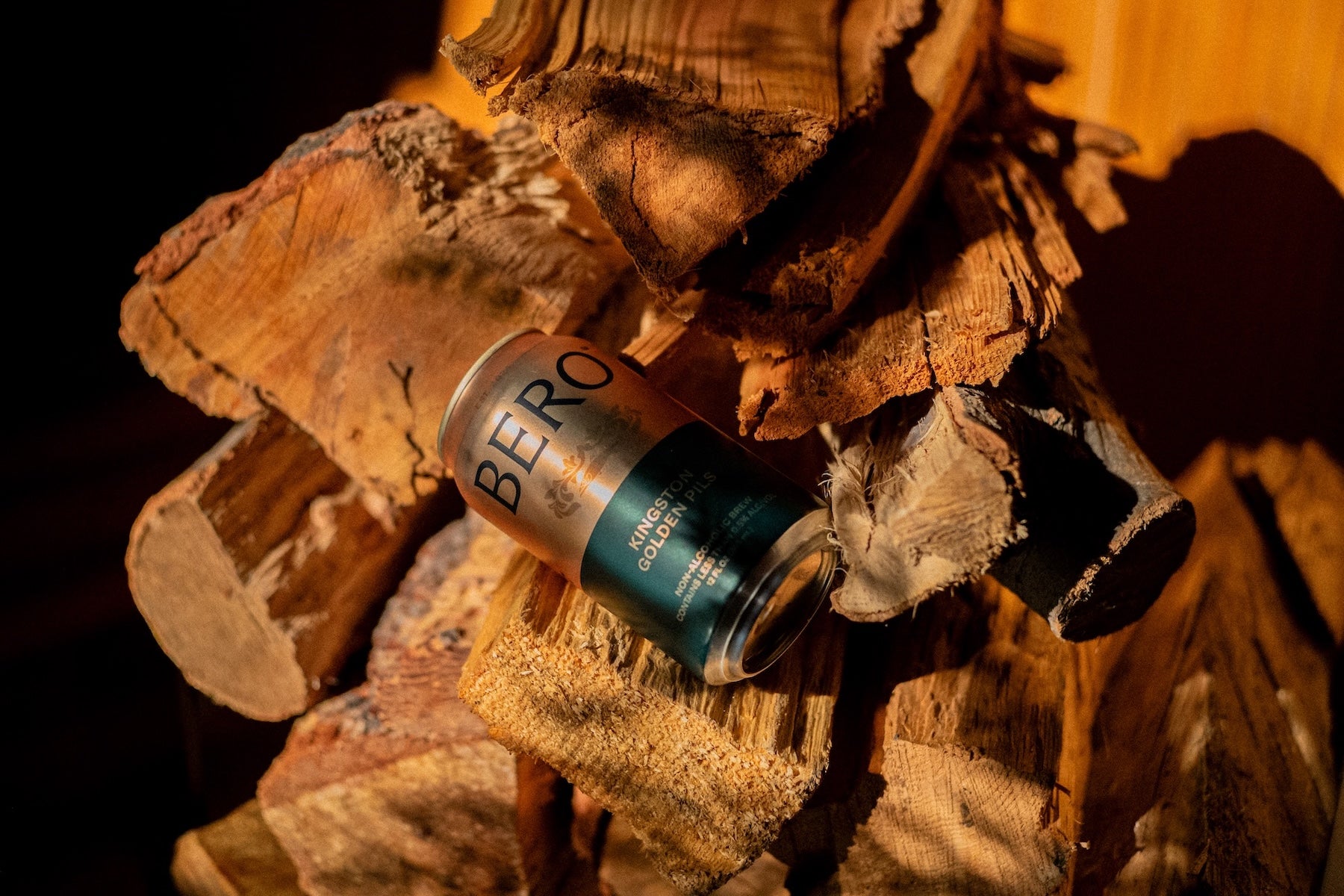 Kingston Golden Pils can on top of firewood