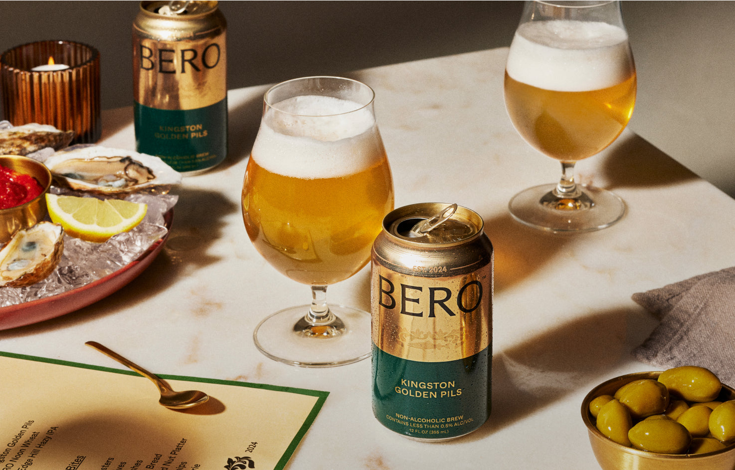 Kingston Golden Pils on table with oysters and olives