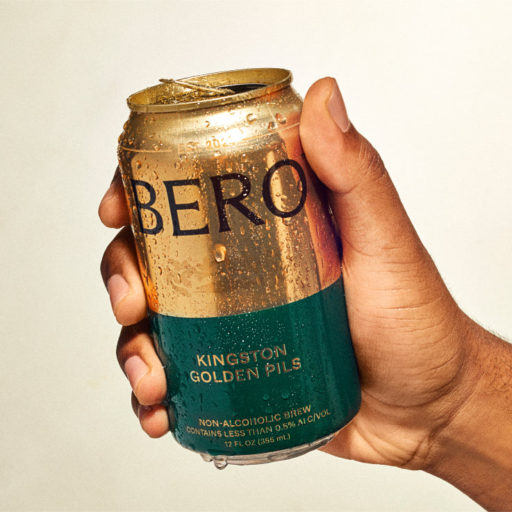 Hand holding can of Kingston Golden Pils