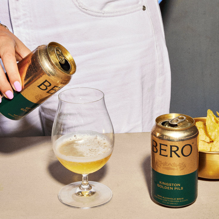 Hand pouring Kingston Golden Pils into glass