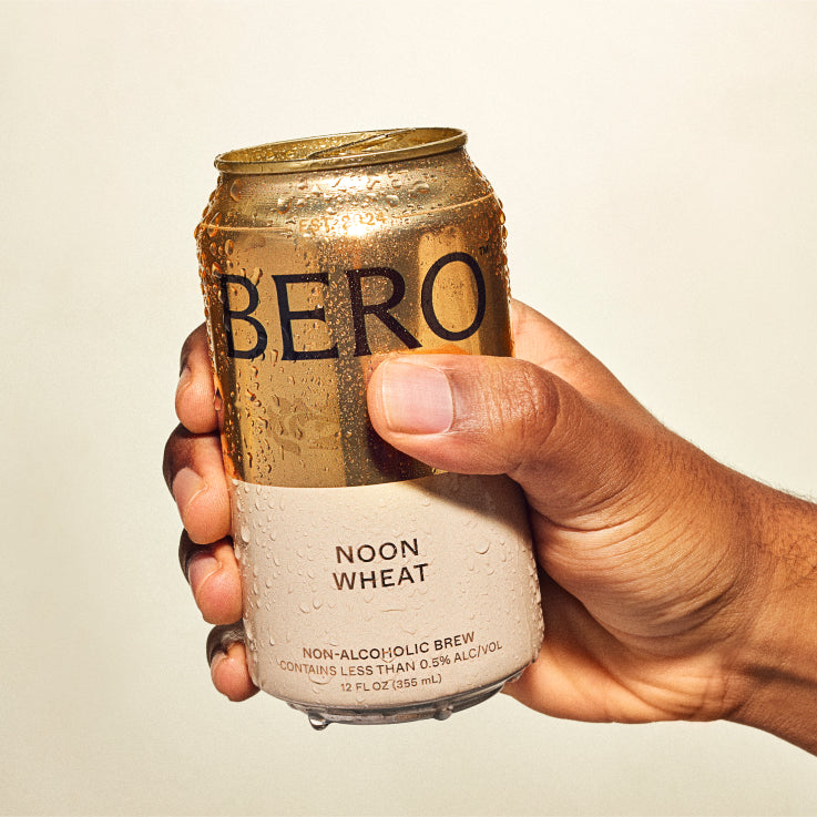 Hand holding Noon Wheat can