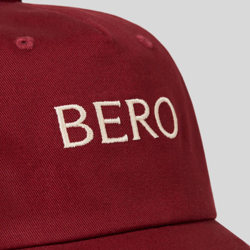 Red baseball cap with white embroidered "BERO" text on the front panel