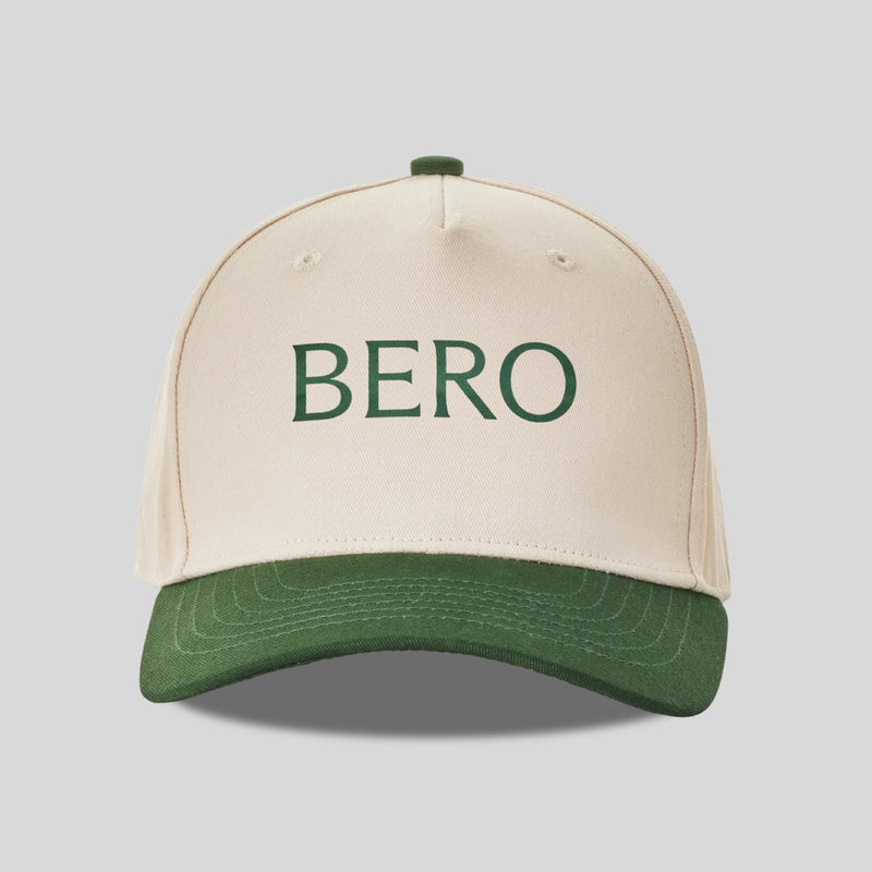 Cream-colored baseball cap with green brim and "BERO" text embroidered in green letters on the front