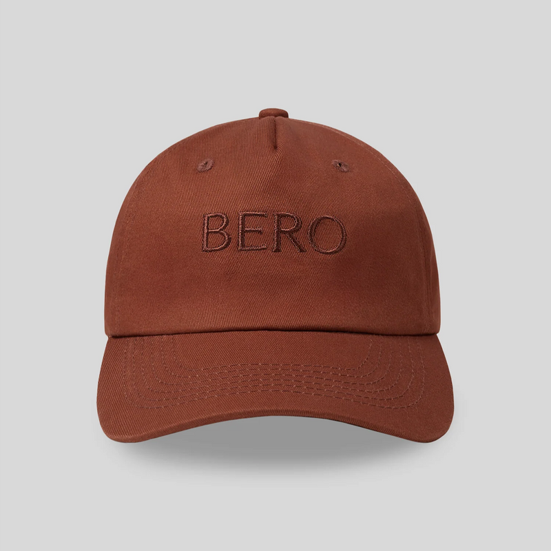 Rust-colored baseball cap with "BERO" embroidered on front in tonal stitching