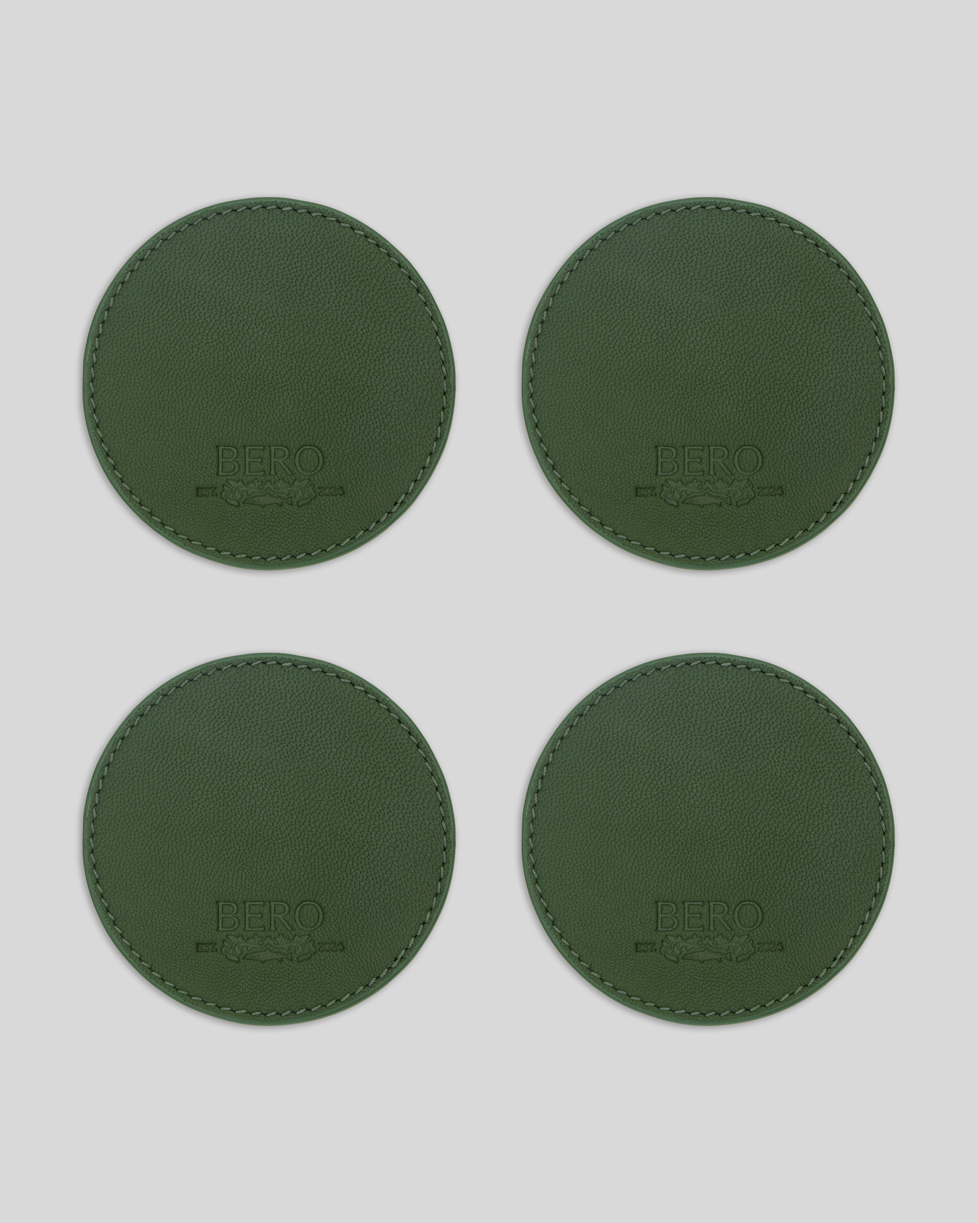 Four green coasters with BERO embroidery