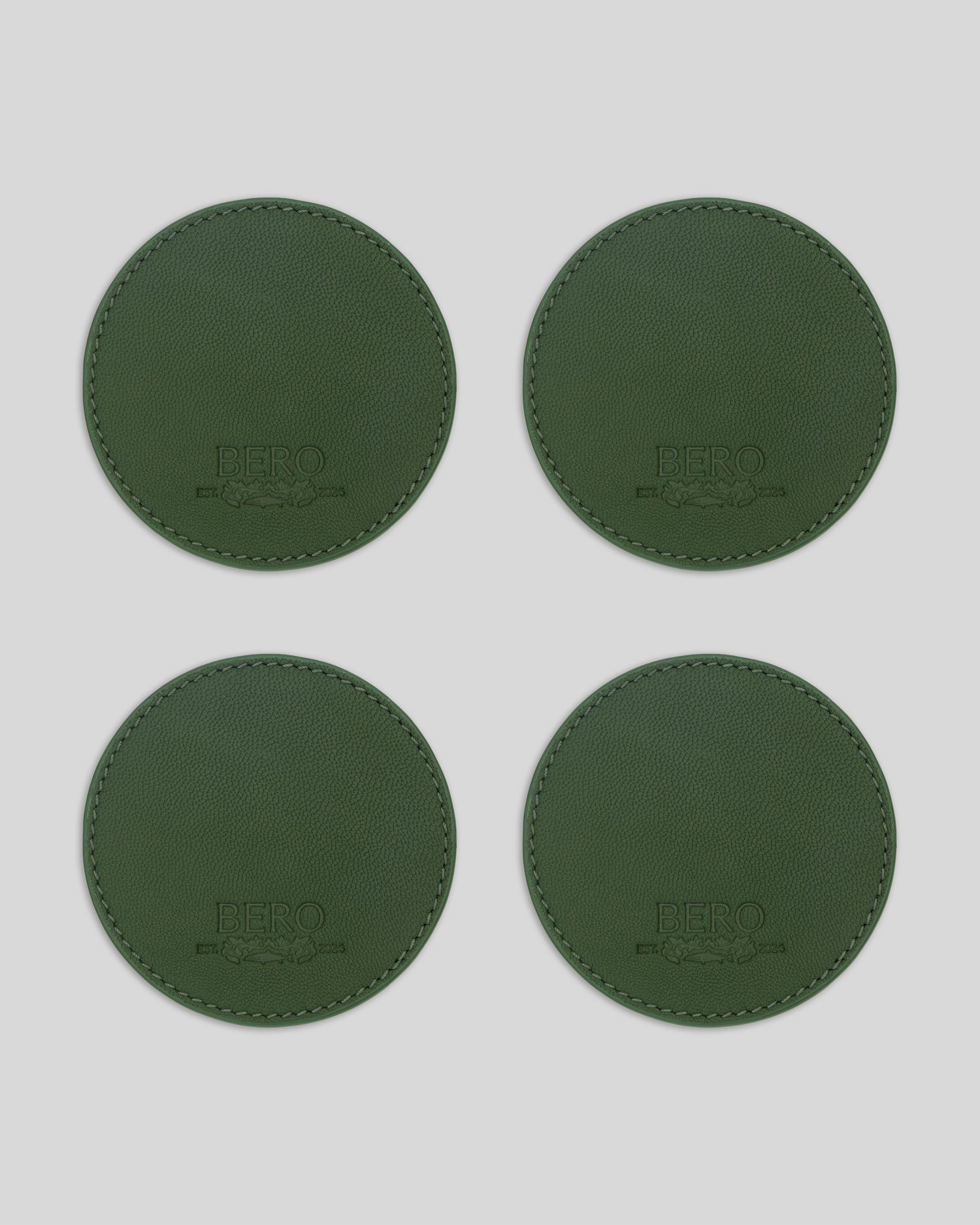 Four green coasters with BERO embroidery