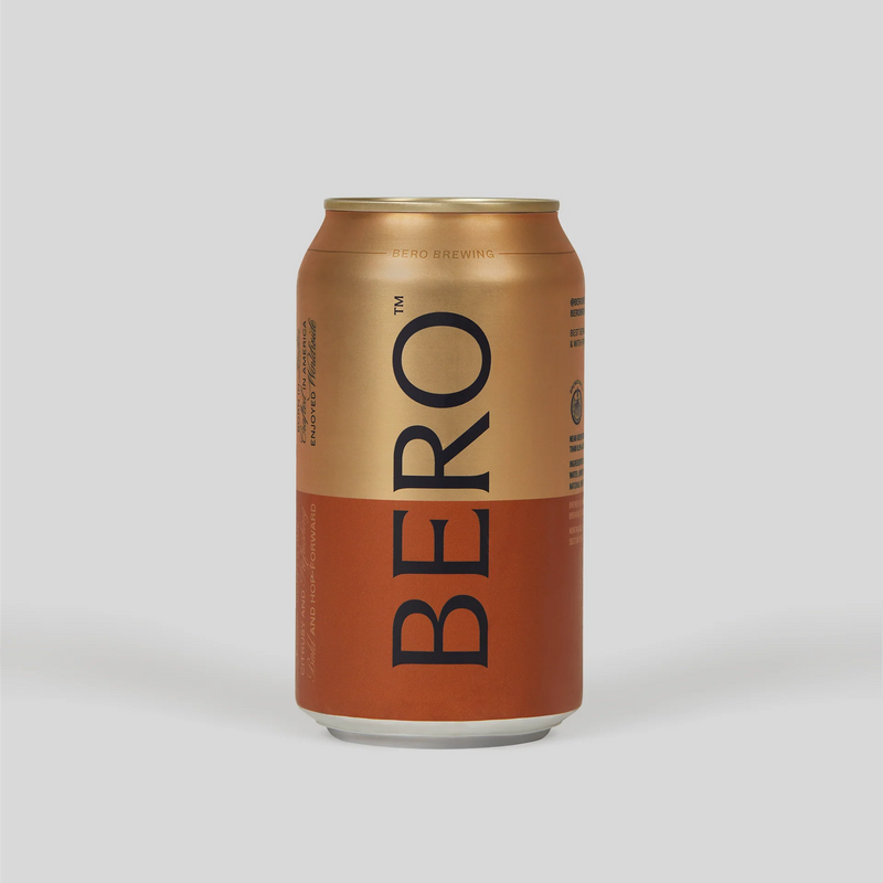 BERO non-alcoholic beer can in gold and orange gradient design on light background