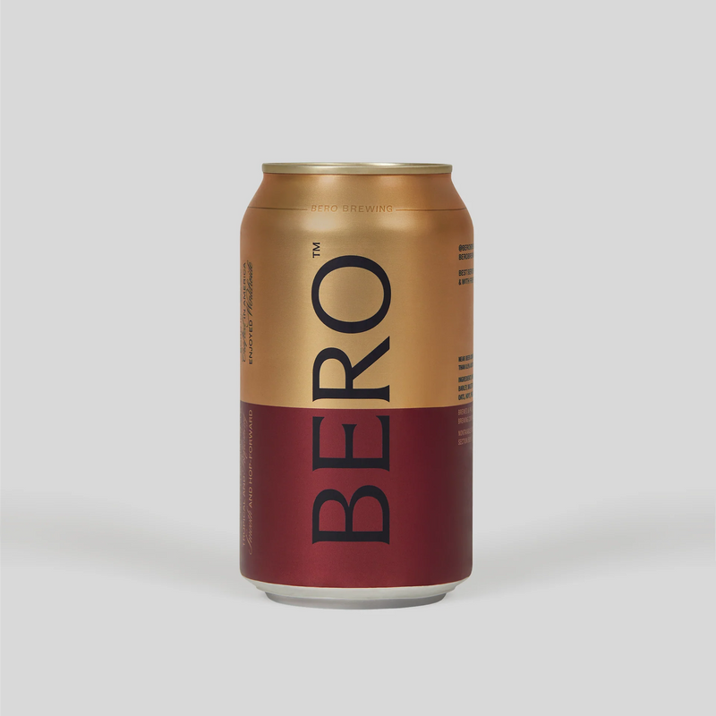 BERO non-alcoholic beer can with gold and burgundy design on light gray background