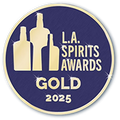 L.A. Spirits Awards Gold 2025 badge with bottles on a blue background