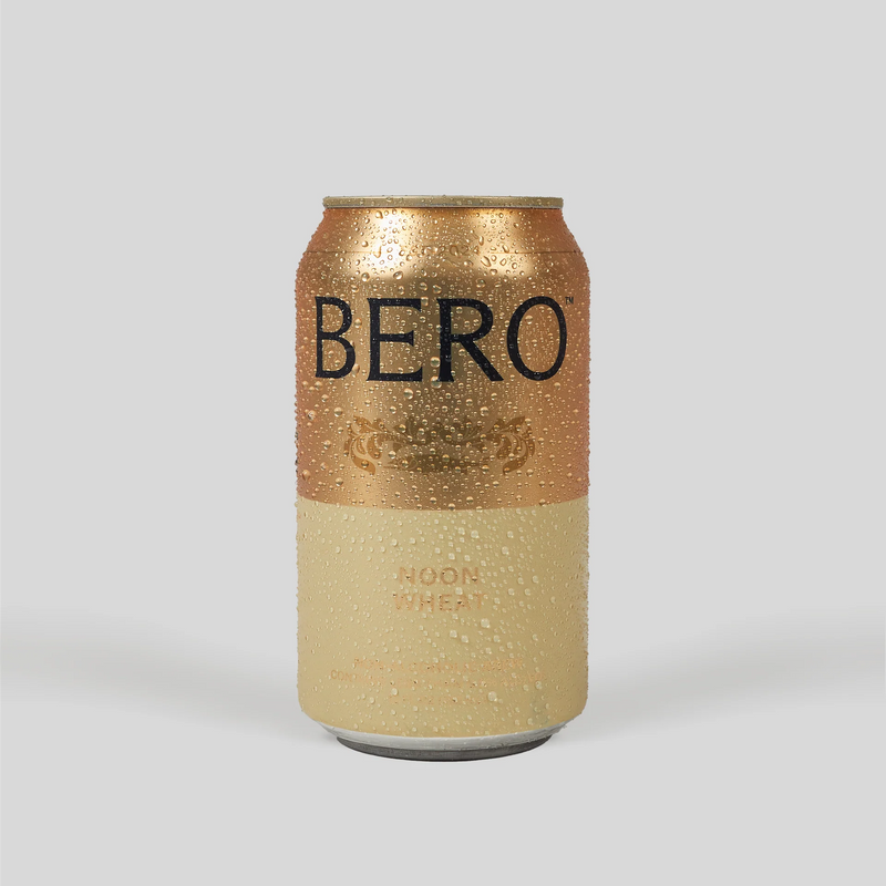 BERO Noon Wheat non-alcoholic beer can with golden and cream colored design, covered in condensation droplets