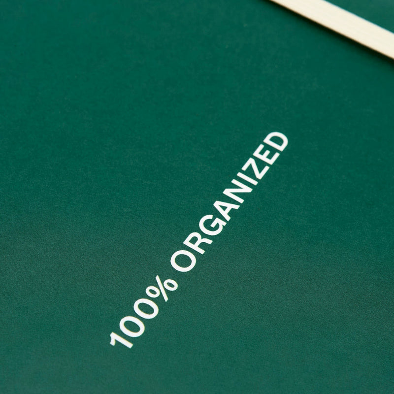 Green notebook cover with white text reading "100% ORGANIZED" printed diagonally across the surface