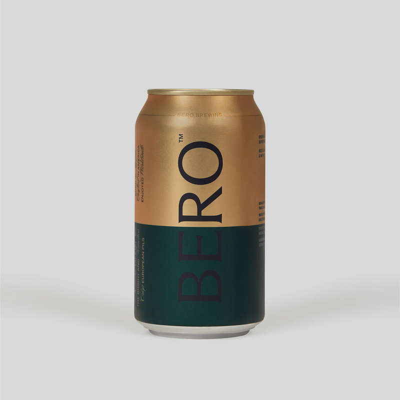 BERO Kingston Golden Pils non-alcoholic beer can with gold upper half and dark green lower half on light background