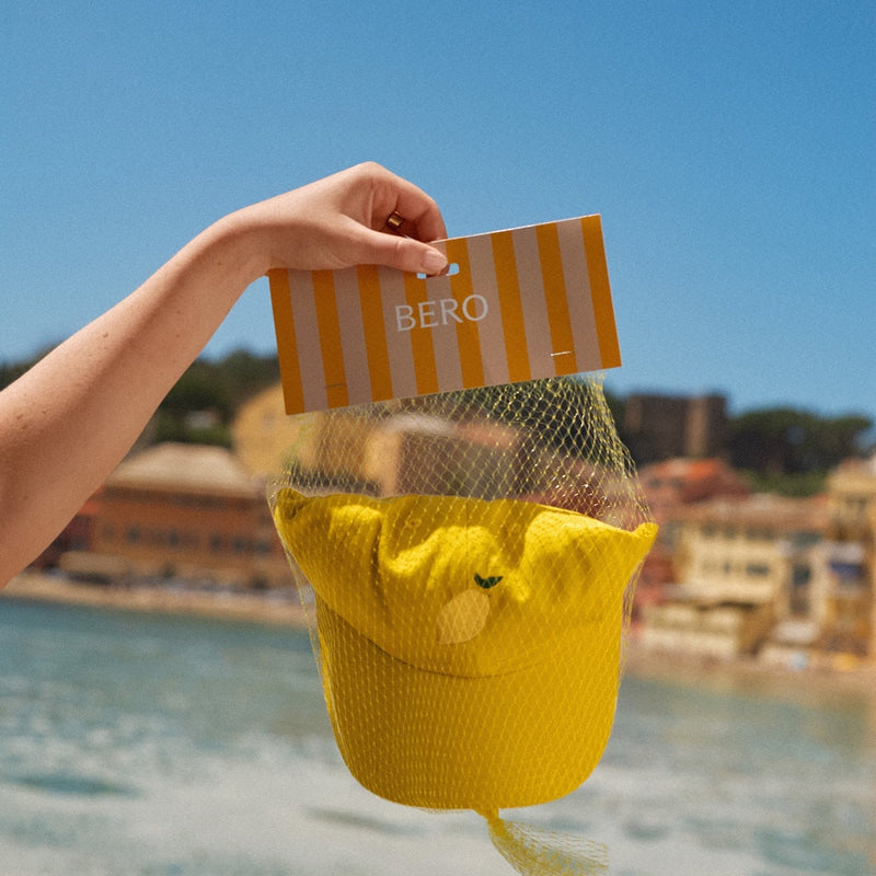 Shandy cap inside mesh bag on a beach