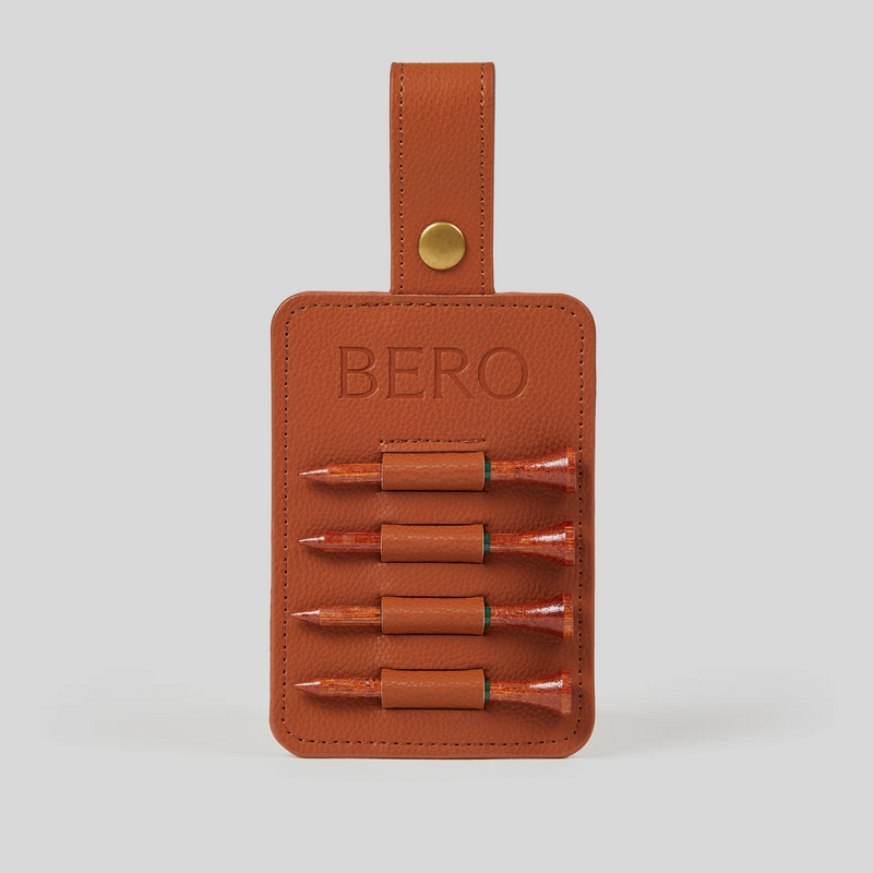 Brown leather golf tee holder with "BERO" embossed text, brass snap closure, and four wooden golf tees secured in elastic loops